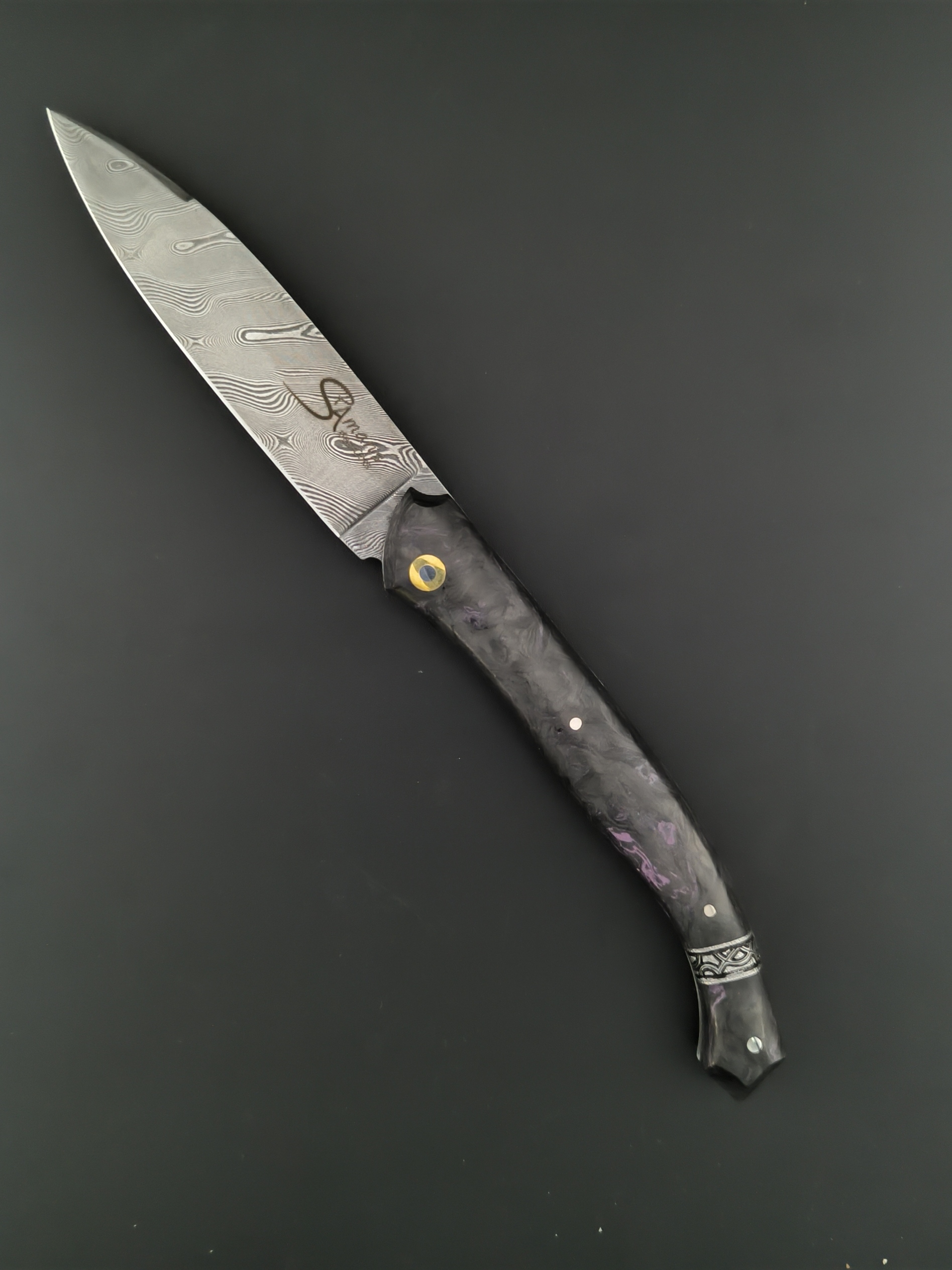 Le couteau Saint-Amans-des-Cots mitre sur l'arrière gravée. fibre de carbone. lame damas